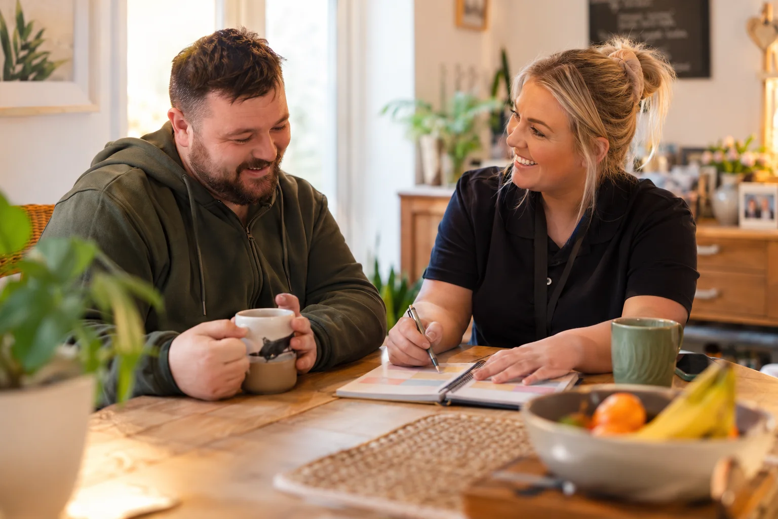 A support worker sharing a happy moment with a person we support